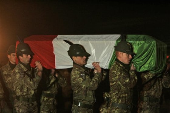 Italian soldiers carry the coffin of their fallen colleague, Pvt. Matteo Miotto, towards an aircraft at Regional Command West military camp in Herat, west of Kabul, Afghanistan, on Saturday, Jan. 1. 